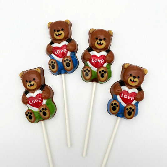 Adorable brown chocolate bear sucker with green or blue pants and suspenders, holding a heart-shaped sign saying LOVE.