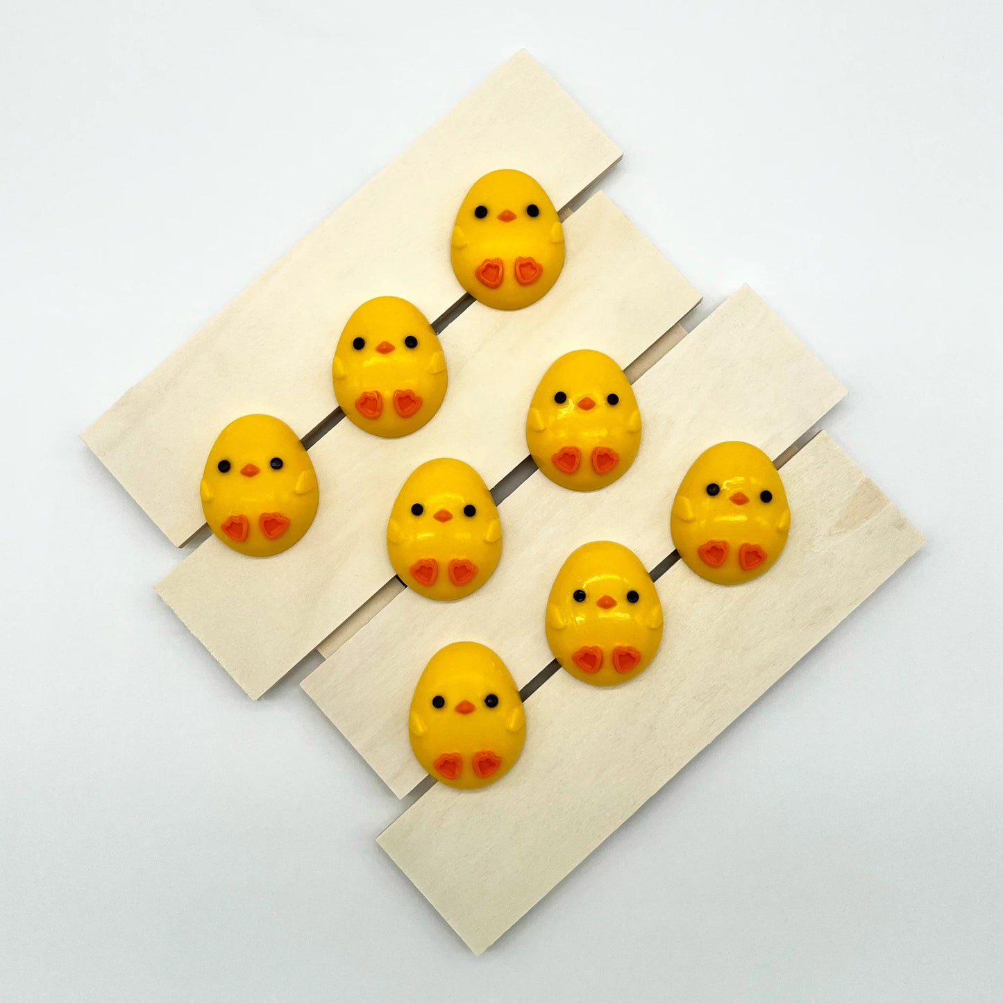 Adorable oval-shaped yellow chick with little orange feet and beak, filled with white chocolate. Perfect for baby showers.