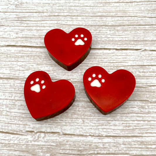 Red heart with a little white paw print on the top part. Made from chocolate.