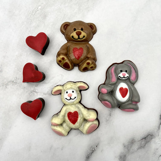 Bear, Rabbit and Lamb Stuffies made from chocolate. Traditional stuffed animal colour palette used for each, with a red heart on each of their tummies.