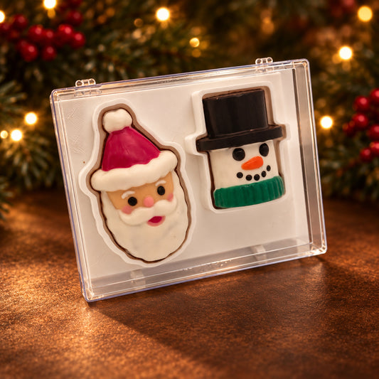 Retro-style chocolate Santa and snowman faces in a clear acrylic gift box.