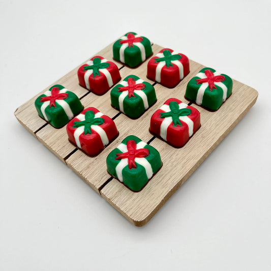 Delightful square Christmas presents made from chocolate; green with white ribbon and red bow, red with white ribbon and green bow.