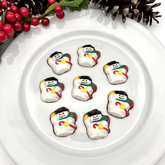Detailed chocolate snowman with a black hat, red cane, green scarf, yellow mittens, orange nose and black "coal" eyes and mouth.
