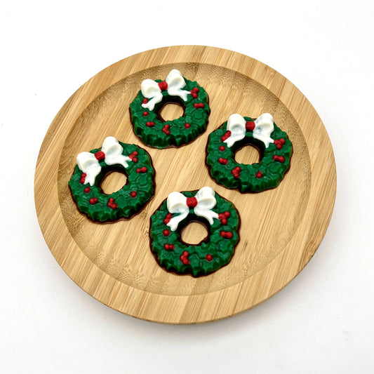 Chocolate Christmas wreaths, coloured in traditional green with red berries and white bow.