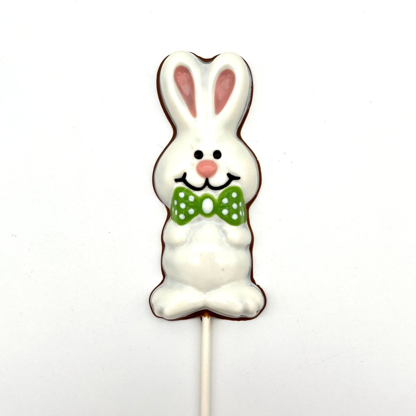 Chocolate Easter Bunny sucker coloured in white and pink, adorned with green polka dot bowtie.