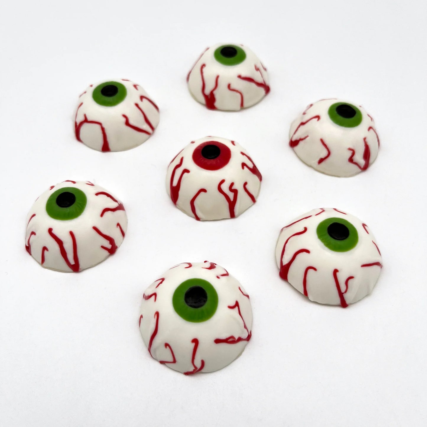 Bloodshot eyeballs made out of chocolate. All have black pupils, some with red irises and some with green iris.
