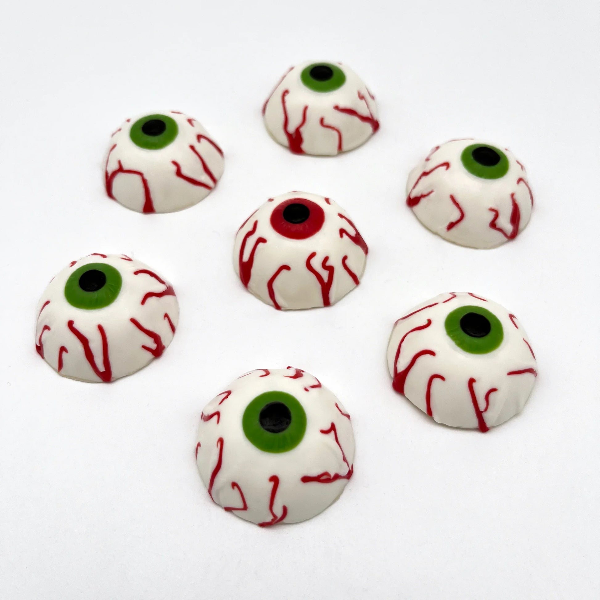 Bloodshot eyeballs made out of chocolate. All have black pupils, some with red irises and some with green iris.