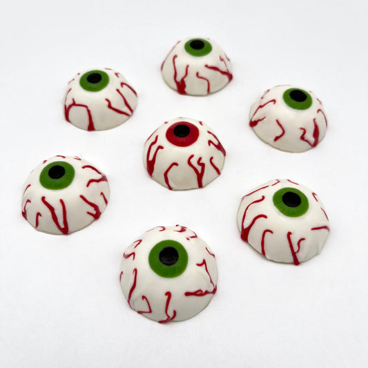 Bloodshot eyeballs made out of chocolate. All have black pupils, some with red irises and some with green iris.