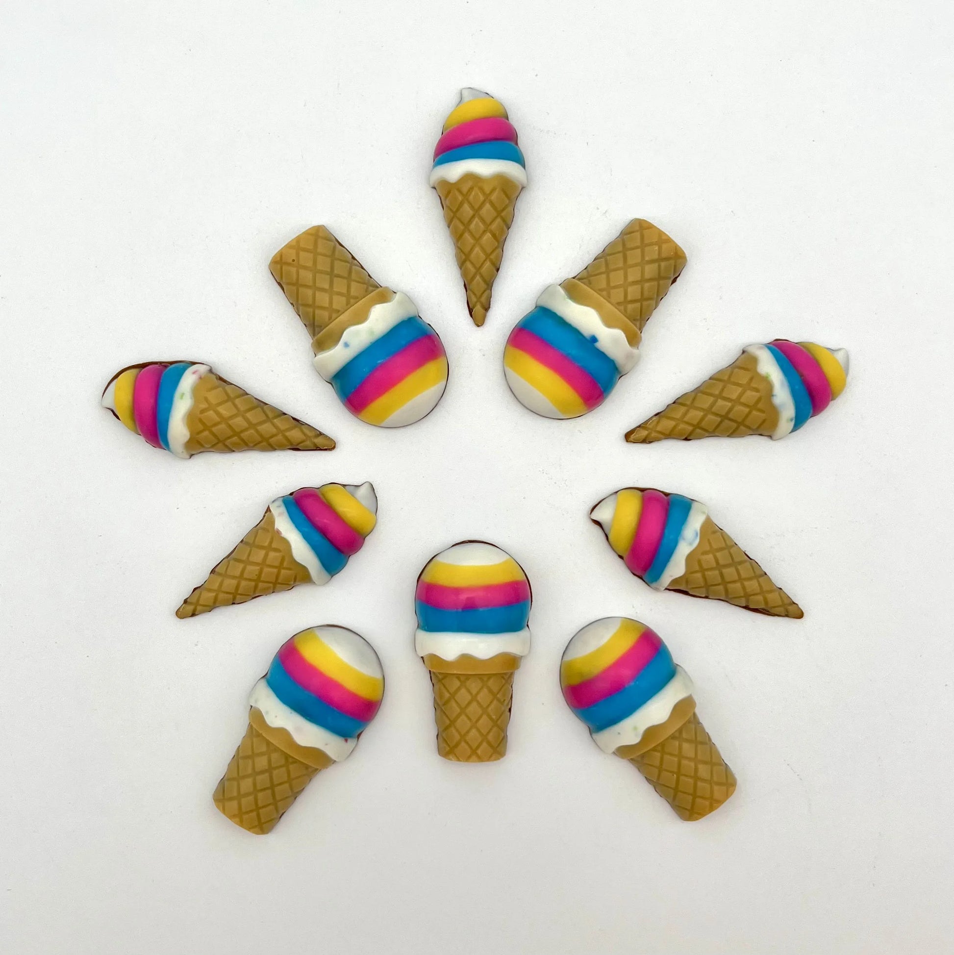 Vibrant chocolate ice cream cones arranged in a circular pattern. Hand-painted in bright rainbow colours and detailed waffle-like cone.