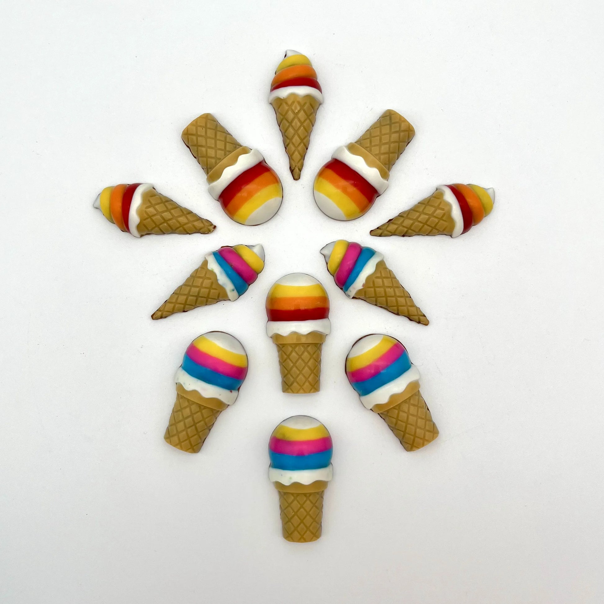 Vibrant chocolate ice cream cones arranged in a circular pattern. Hand-painted in bright rainbow colours and detailed waffle-like cone.