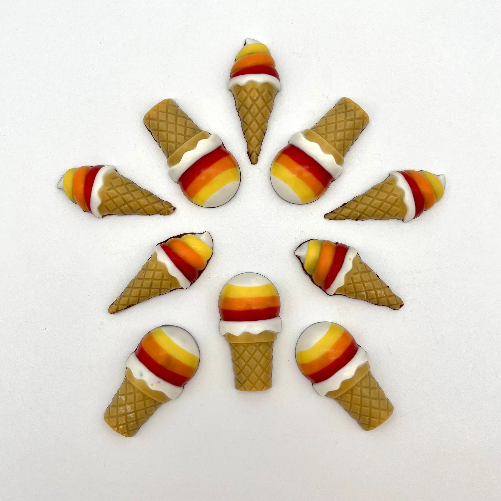 Vibrant chocolate ice cream cones arranged in a circular pattern. Hand-painted in bright rainbow colours and detailed waffle-like cone.