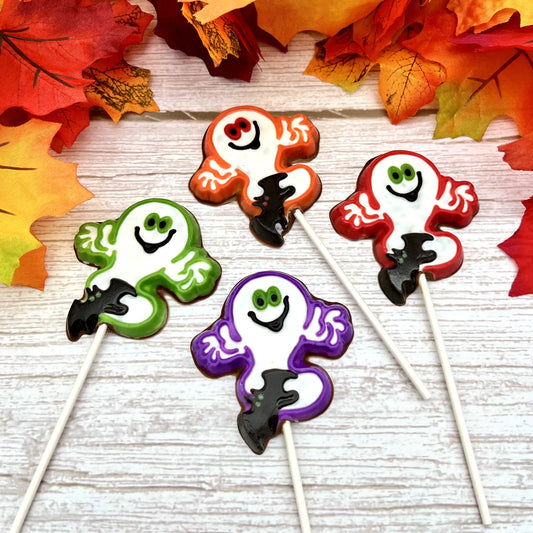 Halloween-themed chocolate suckers of ghosts with black bat. Outlined in red, green, purple or orange, filled in white with big smile and eyes.