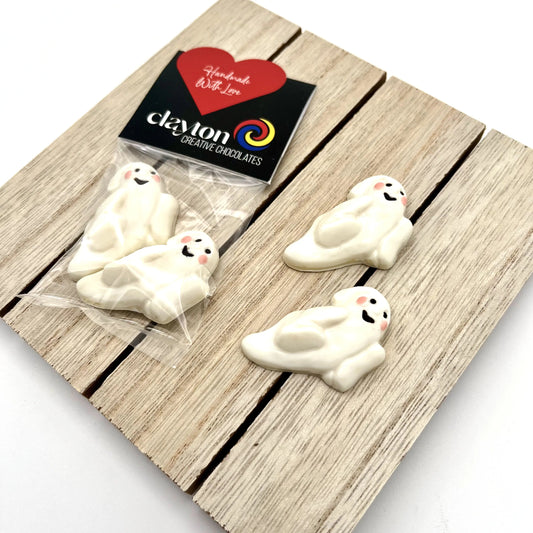 Happy chocolate ghosts, just like a traditional white sheet ghost costume, with black cutout eyes and mouth, and little pink cheeks.