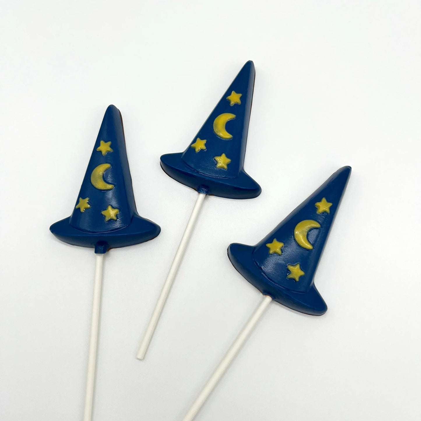 Blue witch hats with yellow stars and moon; all made from chocolate.