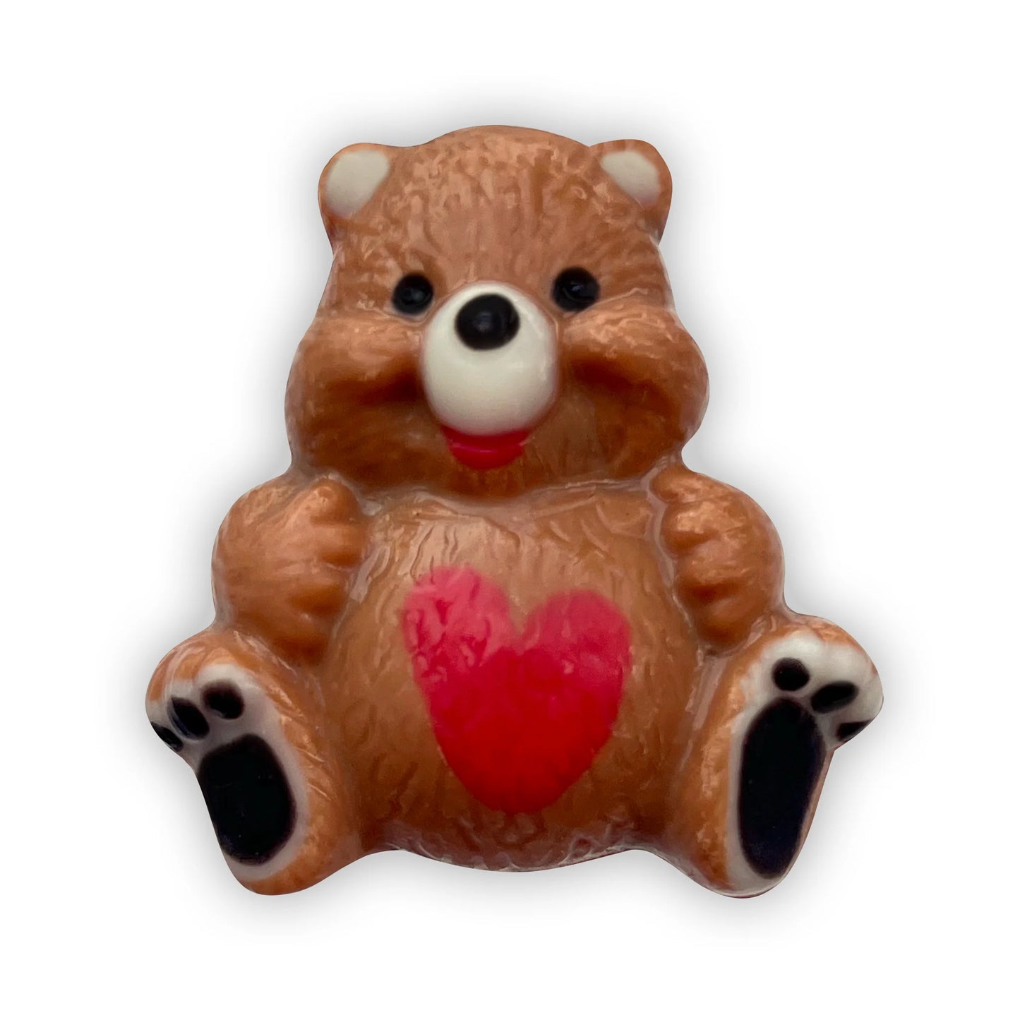 Chocolate bear sitting down, decorated in brown and beige, with a red heart on its tummy and black paws. 