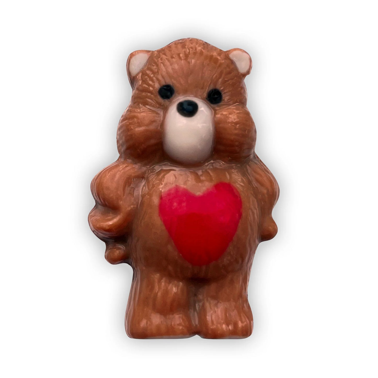Cute chocolate bear in a pouty stance, decorated in brown and beige, with a red heart on its tummy and black paws. 