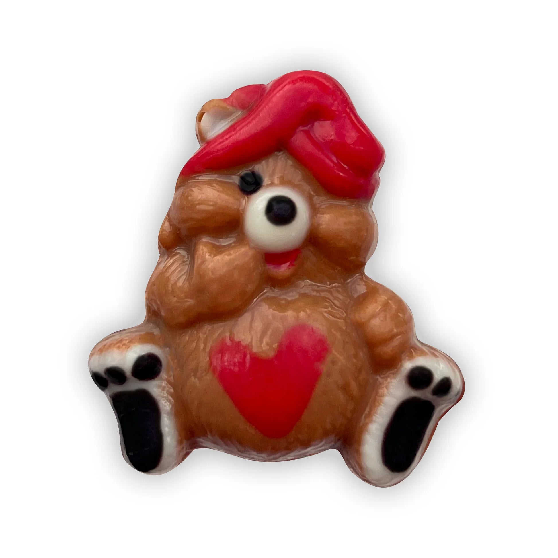 Chocolate bear sitting down, decorated in brown and beige, with a red nightcap, red heart on its tummy and black paws. 
