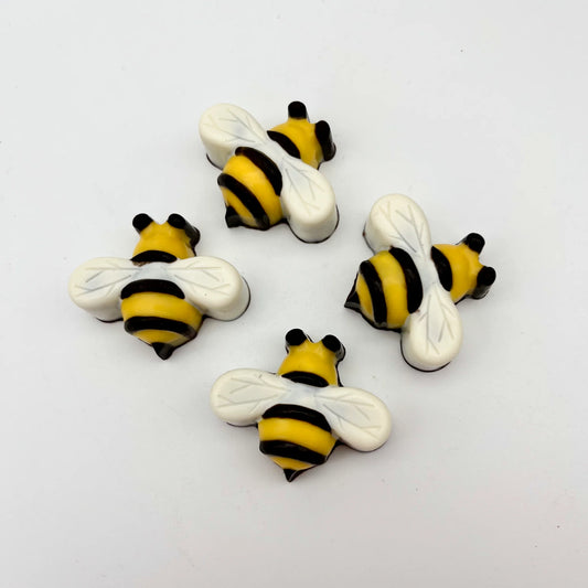 Chocolate bees, hand-painted in traditional yellow and black stripes , black eyes and white wings.