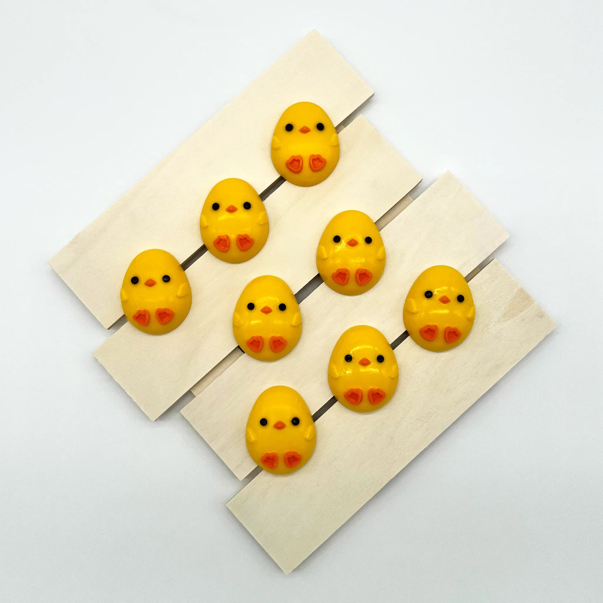 Adorable oval-shaped yellow chick with little orange feet and beak, filled with white chocolate. Perfect for baby showers.