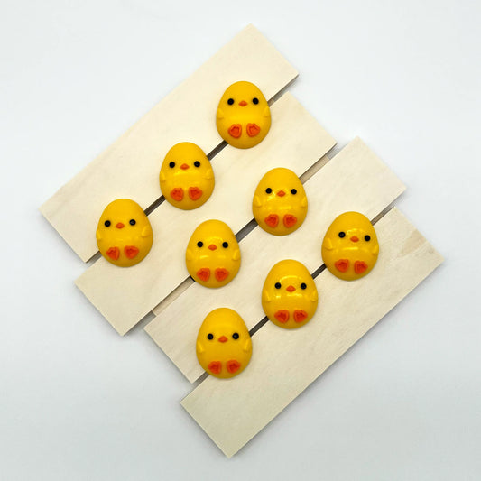 Adorable oval-shaped yellow chick with little orange feet and beak, filled with white chocolate. Perfect for baby showers.