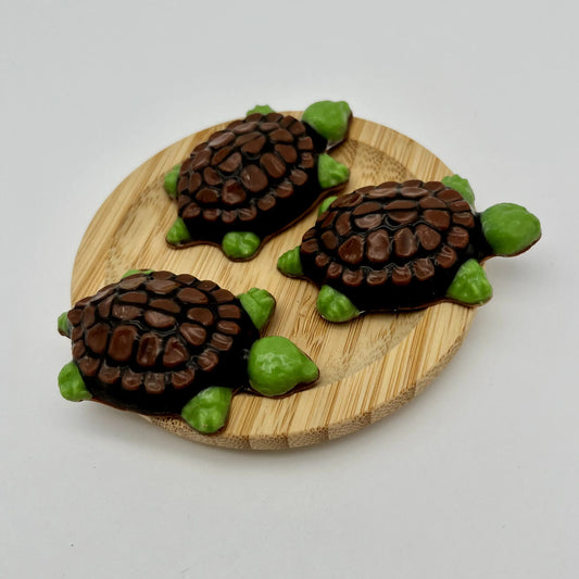 Green chocolate snapping turtles with intricately detailed black shell with brown spots.