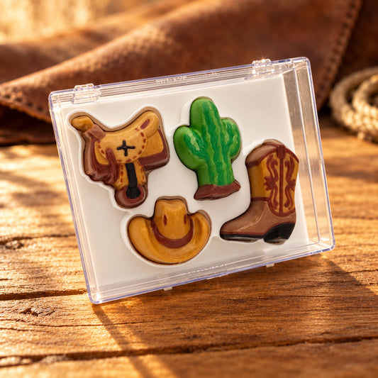 Chocolate saddle, cactus, cowboy hat and boot in a clear acrylic gift box.