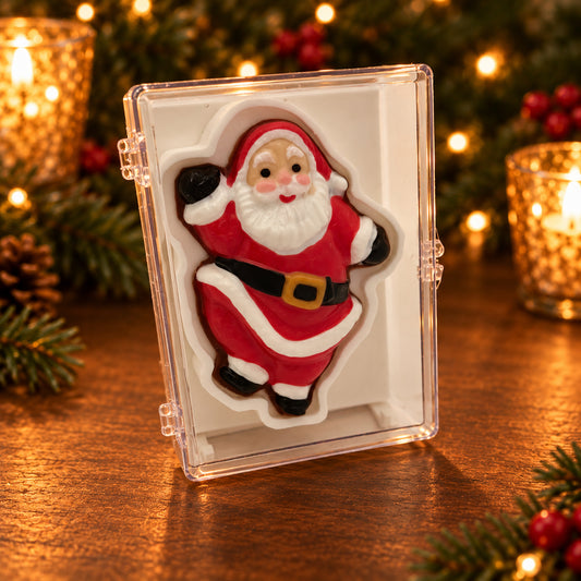 Chocolate Santa in a red suit with one hand raised, displayed in a clear acrylic gift box.