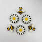 Chocolate bees and daisies, hand-painted in traditional yellow, black and white.