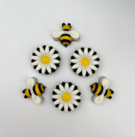 Chocolate bees and daisies, hand-painted in traditional yellow, black and white.