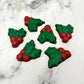 Christmas holly plant in chocolate, with 2 green leaves and 3 red berries.