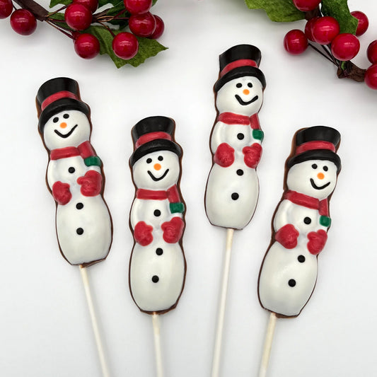 Three chocolate suckers of tall snowmen, adorned with red mittens and scarves, and a black top hat with red band.