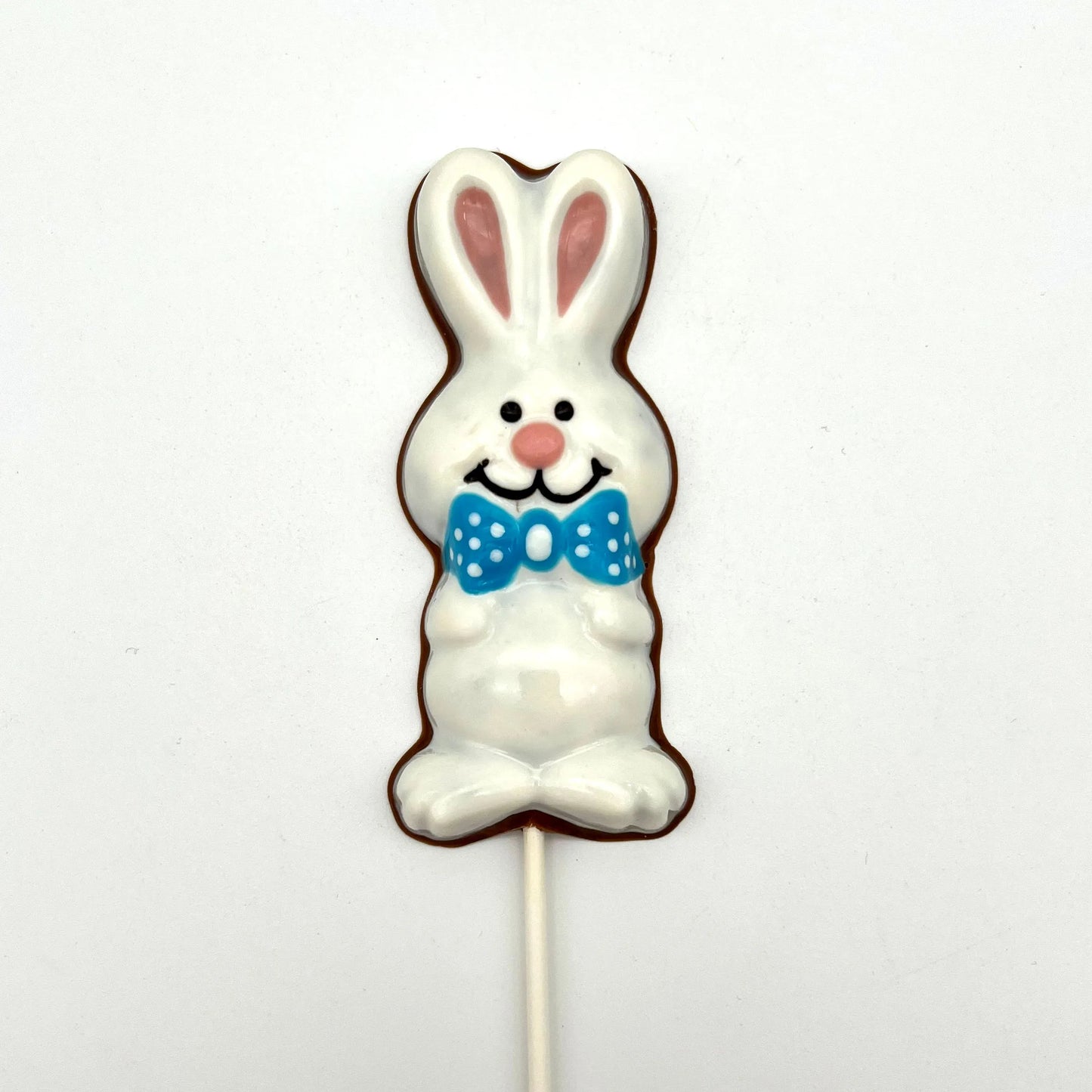 Chocolate Easter Bunny sucker coloured in white and pink, adorned with blue polka dot bowtie.