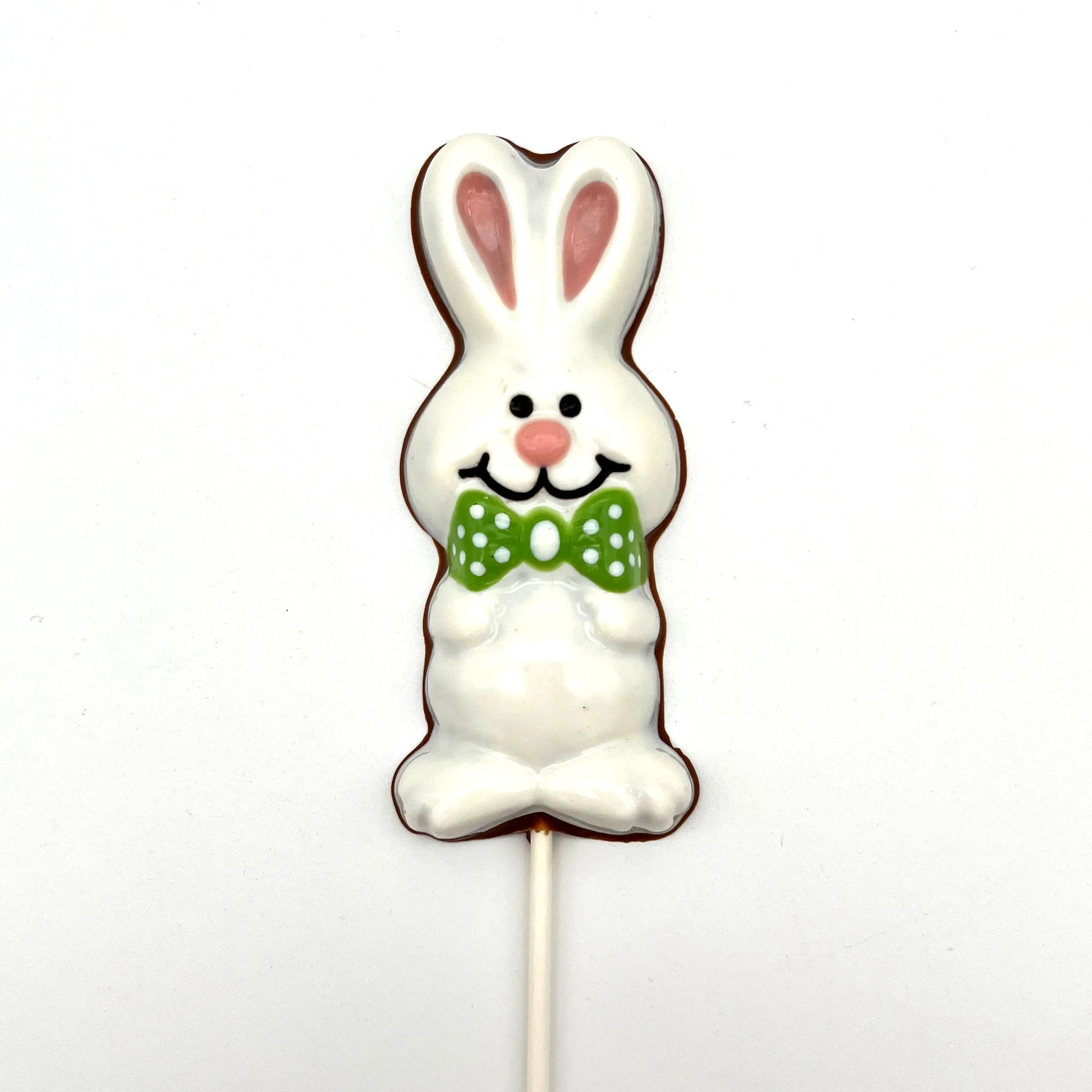 Chocolate Easter Bunny sucker coloured in white and pink, adorned with green polka dot bowtie.