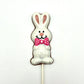 Chocolate Easter Bunny sucker coloured in white and pink, adorned with bright pink polka dot bowtie.