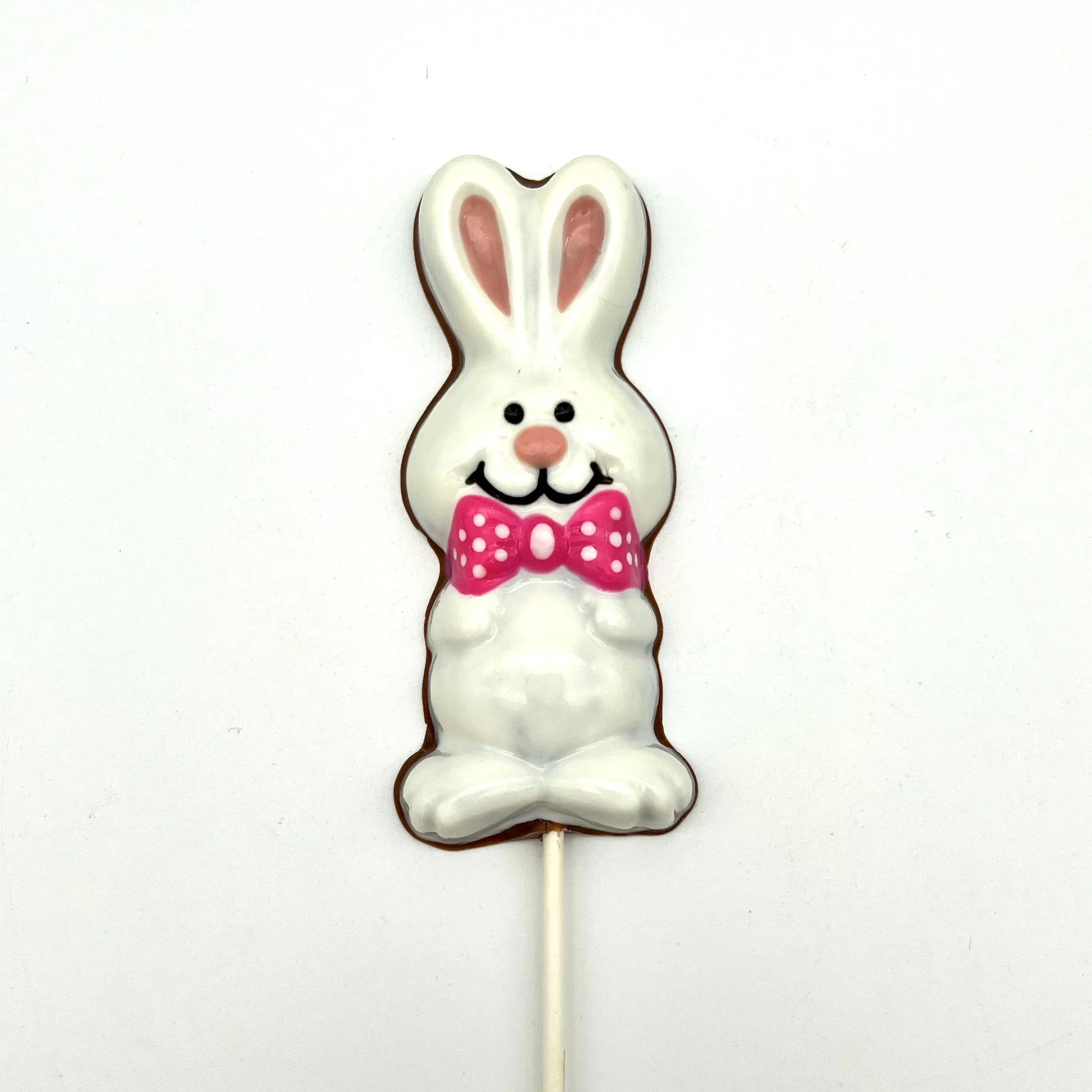 Chocolate Easter Bunny sucker coloured in white and pink, adorned with bright pink polka dot bowtie.
