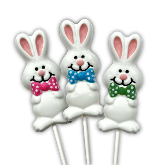 Easter Bunny suckers coloured in white and pink, adorned with polka dot bowties in pink, green or blue. Filled with milk chocolate.