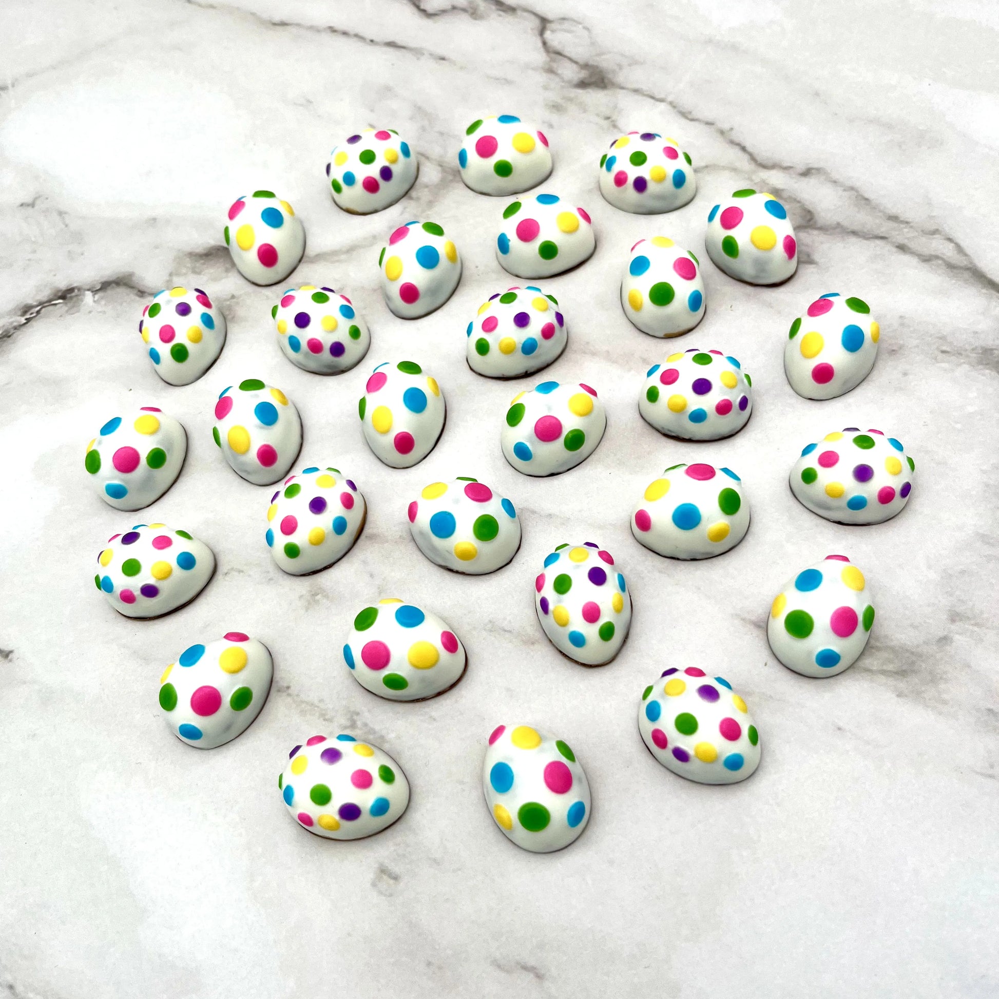 Mini chocolate easter eggs decorated with dots in 7 bright colours.