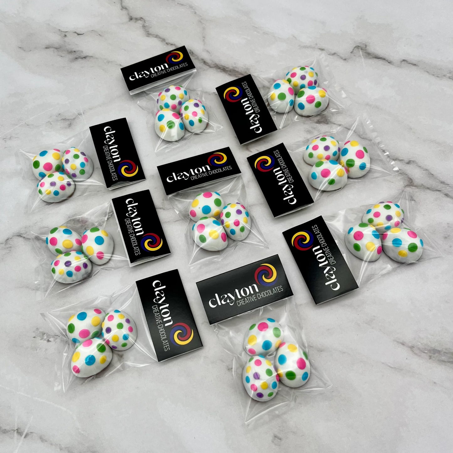 Mini chocolate easter eggs decorated with dots in 7 bright colours. Presented as 3-packs in Clayton Creative Chocolates packaging.