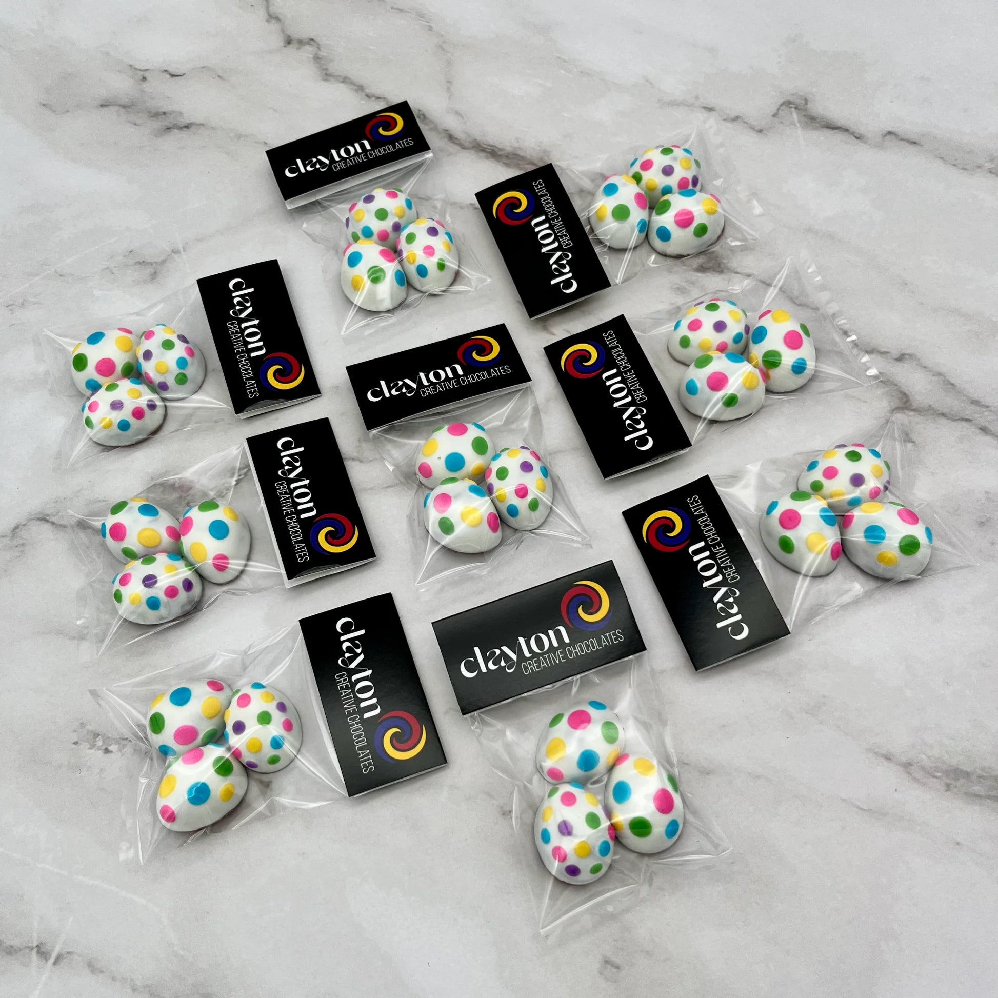 Mini chocolate easter eggs decorated with dots in 7 bright colours. Presented as 3-packs in Clayton Creative Chocolates packaging.