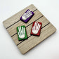 White skeleton hands on a red, purple or green coloured rectangle, all made from chocolate. 