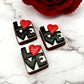 Chocolates with the letters LOVE in white, with the O as a red heart, on a black background.