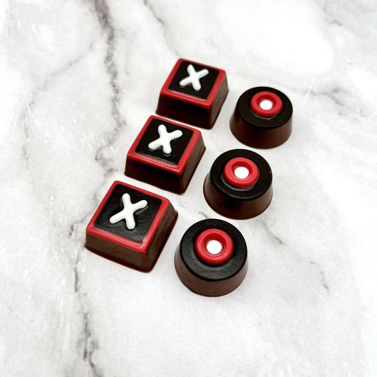 Red, black and white square X's and circular O's chocolates.