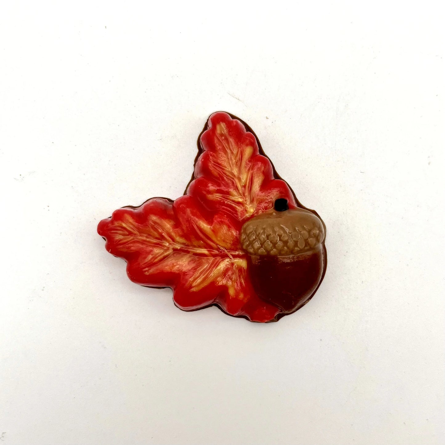 Realistic chocolate oak leaves and acorn, hand-painted in a blend of yellow, orange and red fall seasonal colours.