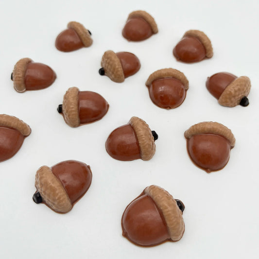 Selection of realistic-looking chocolate acorns in real-life browns and black.