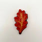 Realistic chocolate oak leaf, hand-painted in a blend of yellow, orange and red fall seasonal colours.
