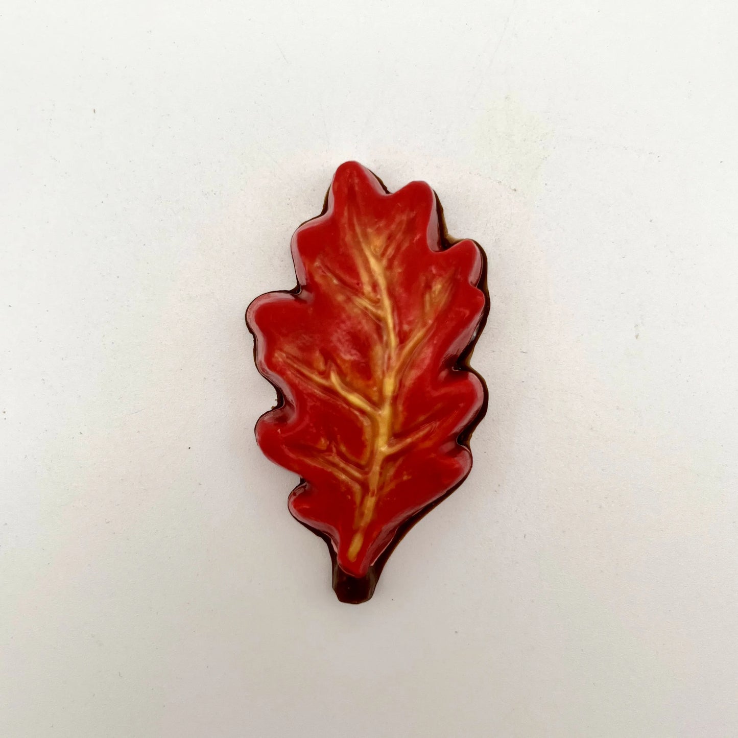 Realistic chocolate oak leaf, hand-painted in a blend of yellow, orange and red fall seasonal colours.