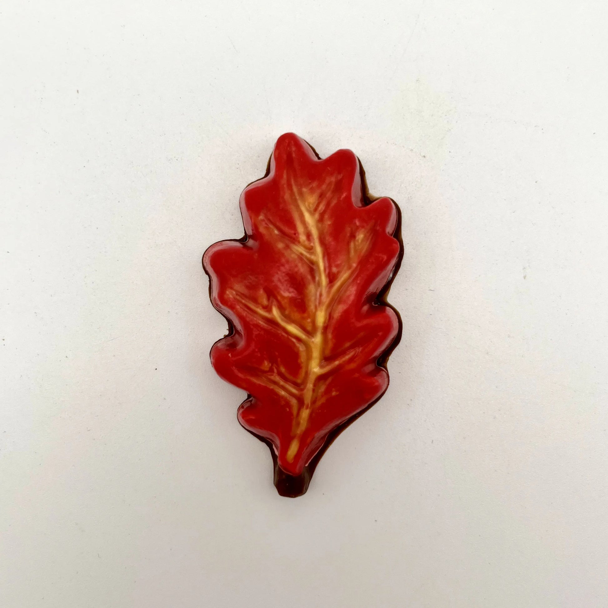 Realistic chocolate oak leaf, hand-painted in a blend of yellow, orange and red fall seasonal colours.