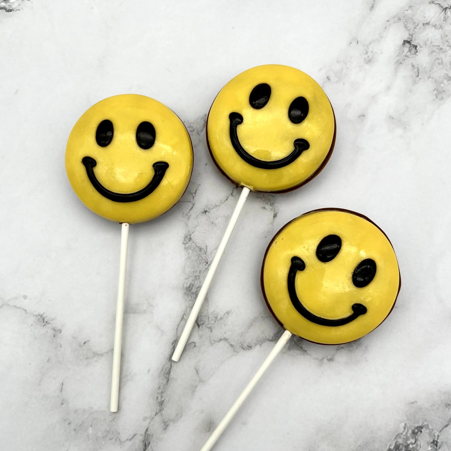 A jumbo version of the classic yellow and black smile emoji, but made from chocolate.